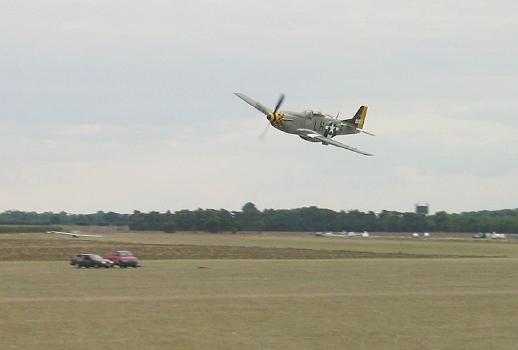 A P-51D passes over